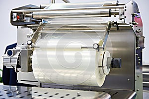 Roll of packaging film on machine food factory