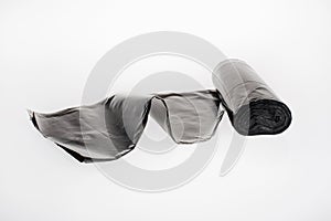 roll of plastic garbage bags isolated on white. Black color nylon roll pochette to remove poo of for pets