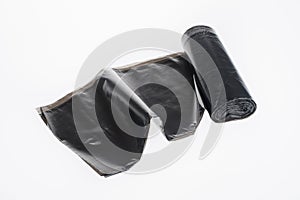 roll of plastic garbage bags isolated on white. Black color nylon roll pochette to remove poo of for pets