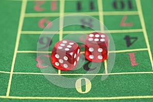 Roll of the red dice on a game table in a casino