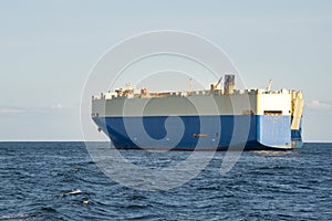 Roll-on roll-off RORO or ro-ro ships or oceangoing vehicle carrier ship anchor in the open sea