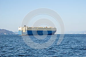 Roll-on roll-off RORO or ro-ro ships or oceangoing vehicle carrier ship anchor in the open sea