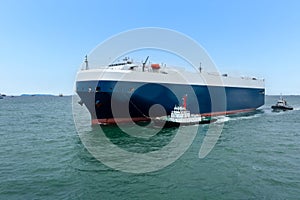 Roll-on Roll-of ship loading new cars line up . Automotive container carriers floating in sea, business services import export