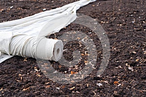 A roll of rolled white geotextile on the ground photo