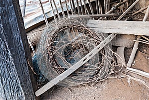 Roll of Rusty Barbed Wire and Dirty Nylon Net