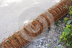 Roll of rusty construction rebar on ground
