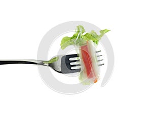 Roll salad on fork isolated on white.