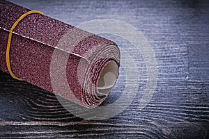 Roll of sandpaper on vintage wooden board abrasive equipment