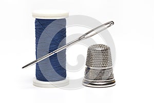 roll sewing thread needle thimble white background