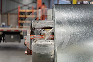 roll of silver metal steel coil in a metal roofing factory