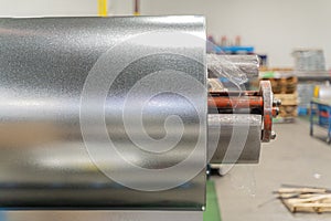 roll of silver metal steel coil in a metal roofing factory
