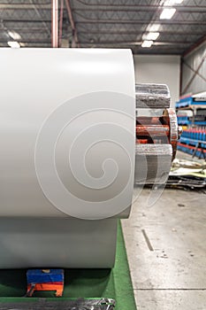 roll of silver metal steel coil in a metal roofing factory