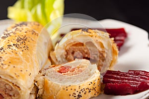 Roll of spicy sausage in flaky pastry