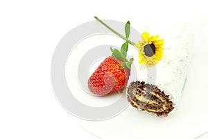 Roll, strawberries and a flower isolated on white