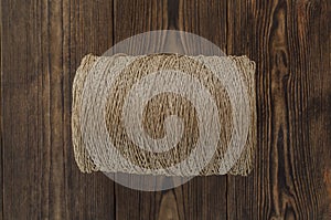 Roll of a twine jute on the wooden background