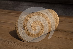 A roll of twine on a wooden background. Selelective focus. Close-up. Free space for text.