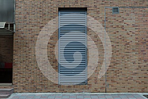 Roll up garage door on brick wall