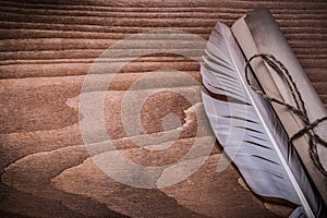 Roll of vintage paper feather on wooden board