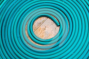 Roll of water hose on concrete floor