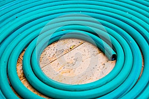 Roll of water hose on concrete floor