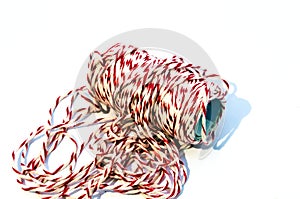 Roll of white and red rope on the white background.