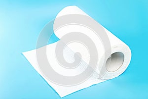 a roll of white toilet paper against a blue background photo