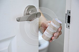 Roll of white toilet paper in a tiled bathroom