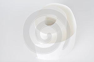 Roll of white toilet paper on white background