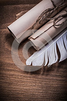 Rolled aged paper quill on wooden board