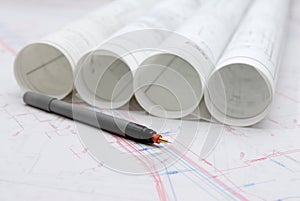 Rolled architectural plans and drawing utensils