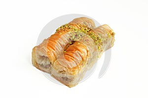 Rolled baklava with pistachios isolated on white background. Turkish delicacy