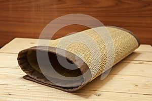 Rolled bamboo place mats on wood background