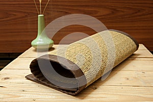 Rolled bamboo place mats on wood background