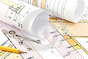 Rolled blueprints and technical drawings with pencil and drawing compass