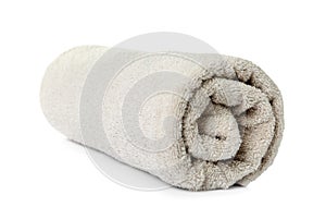 Rolled clean beige towel on background