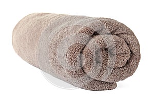 Rolled clean brown towel on background