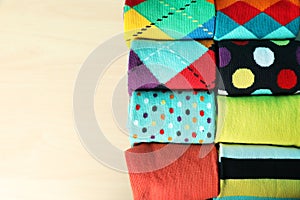 Rolled colorful socks on light background