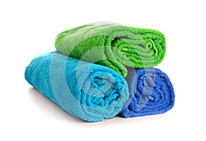 Rolled colorful towels on white background