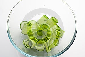 Rolled cucumber slices in glass bowl