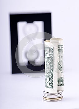 Rolled Dollar Bill On Coin Stack On Focus