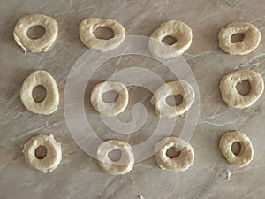 Rolled Dough for donuts. Cutting from fresh dough for traditionally donuts.