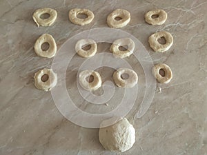 Rolled Dough for donuts. Cutting from fresh dough for traditionally donuts.