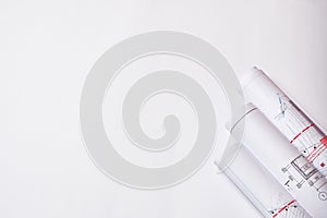 Rolled engineering drawings at white background with copy space
