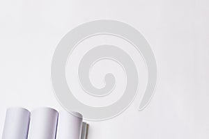 Rolled engineering drawings at white background with copy space