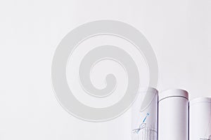 Rolled engineering drawings at white background with copy space