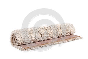 Rolled fuzzy carpet on white background