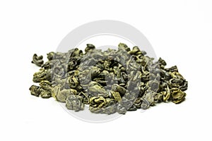 Rolled green tea leaves on a white background