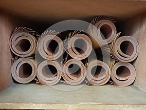 Rolled grit sand paper in a wood shelf