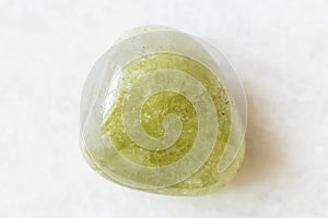 Rolled Grossular green garnet rock on white