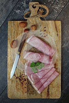 Rolled ham slices with herbs on a table